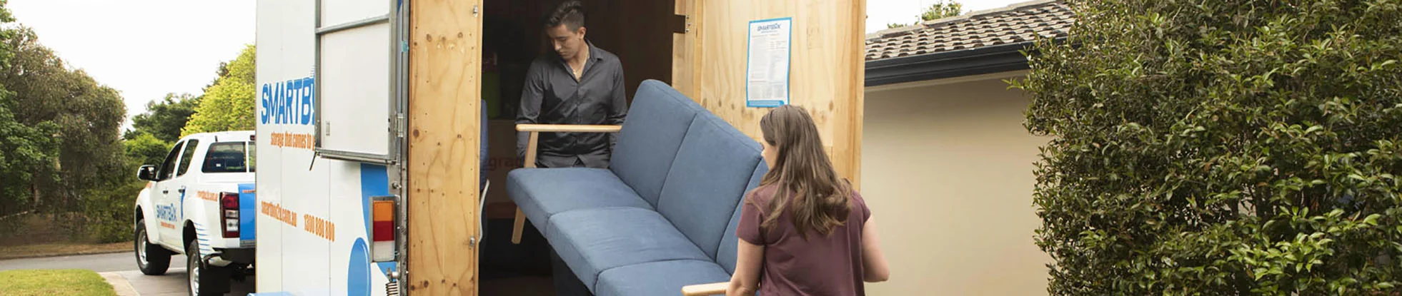 young couple lifting furniture