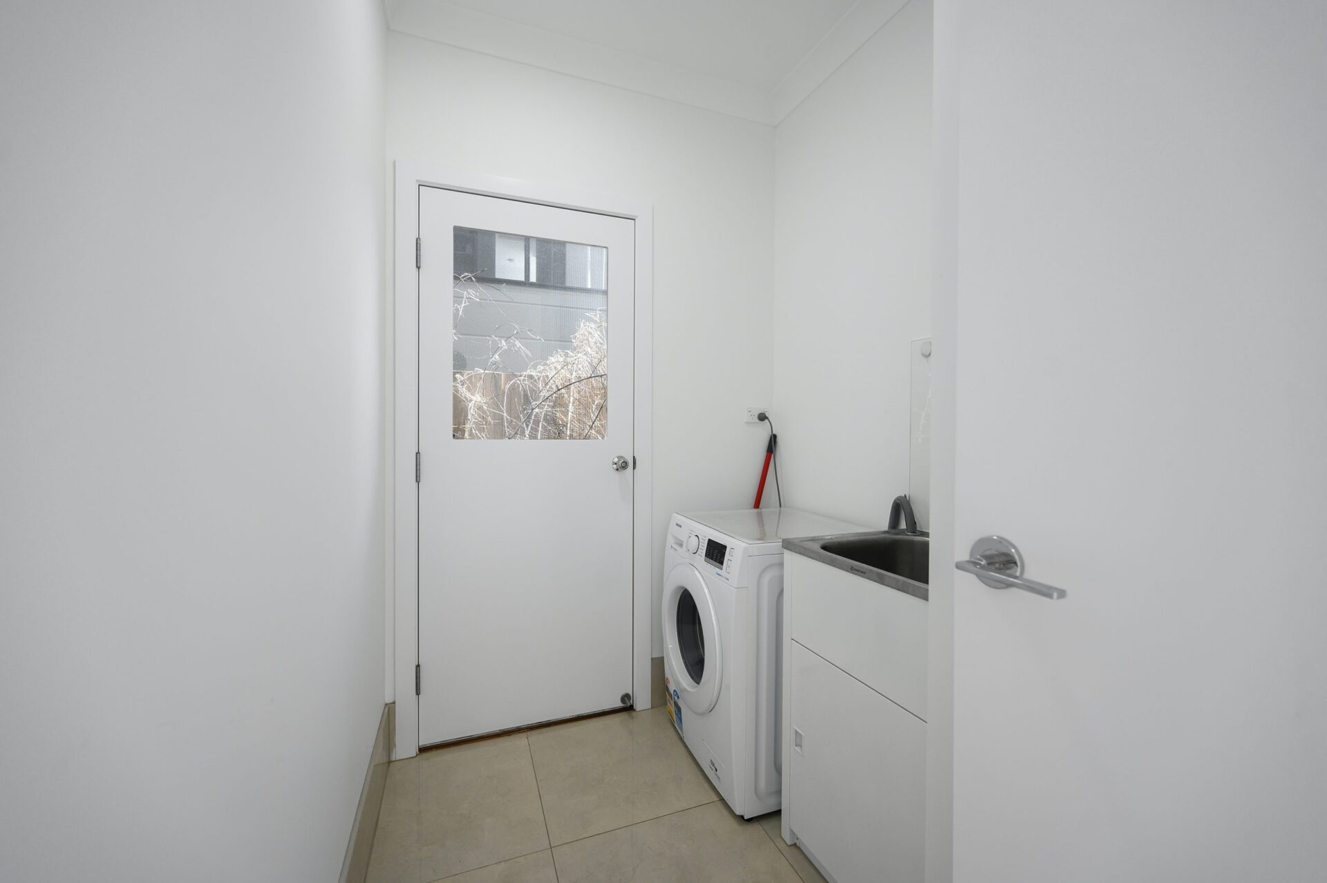 Clean and bright white laundry area with a minimalist design