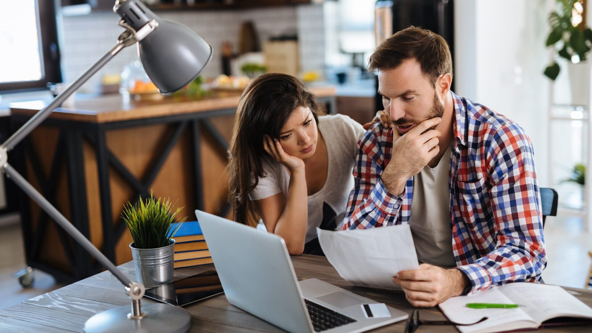 couple paying bills on a laptop